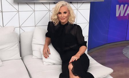 Jenny McCarthy sitting on the couch.