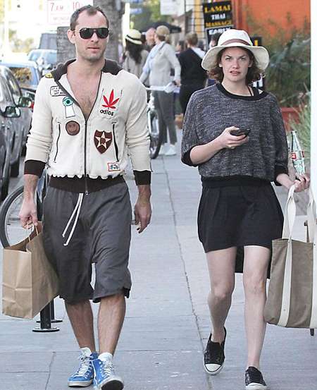 Jude Law and Ruth Wilson walking down the street.