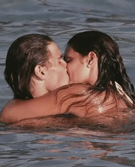 Maria and Rafael kissing in the water.