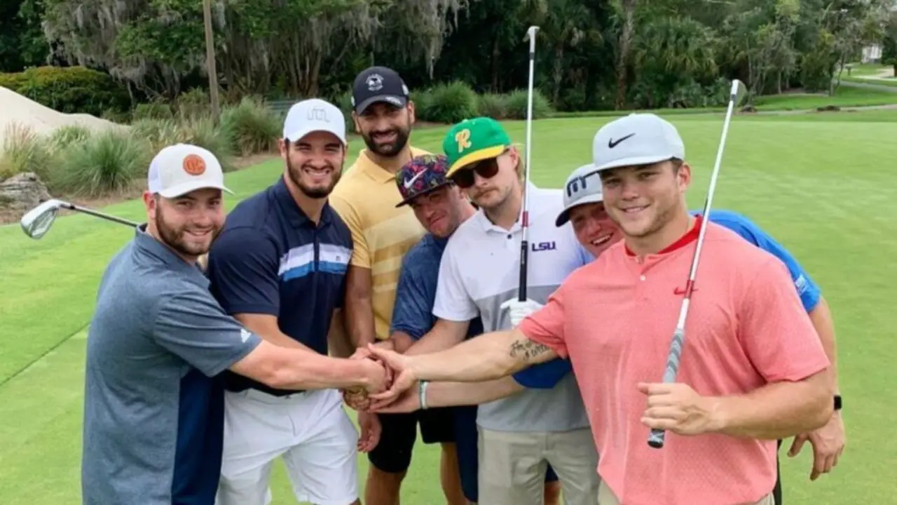 Caleb Pressley shaking hands with his friends after a round of golf.