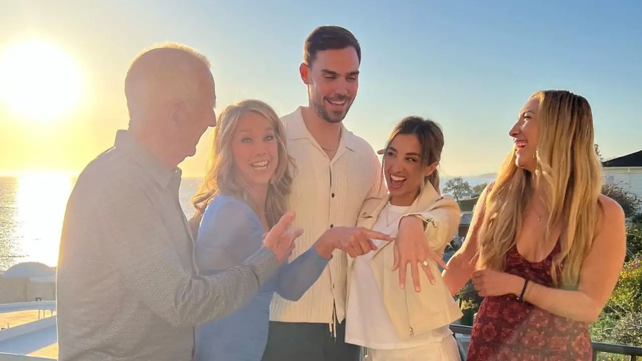 Katie Austin showing off her engagement with her fiancé and family.