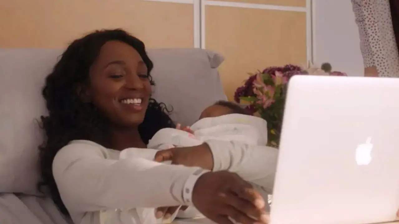 Sloane hugged her baby and grinned at her boyfriend in a virtual conference.
