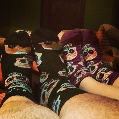 Jorge's and Rebecca's legs only shown wearing matching socks.