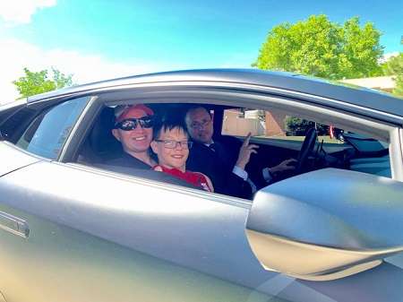 Brandon Fugal in his car with Kevin Matthews, with a birth defect affecting his limbs.