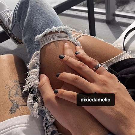 Taylor Holder and Dixie D'Amelio's hands in the aforementioned Instagram post.