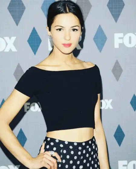 Annet Mahendru taking a picture in front of the FOX board.