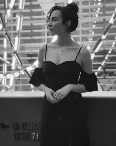 Aurora Perrineau in a black and white image, wearing a dress.