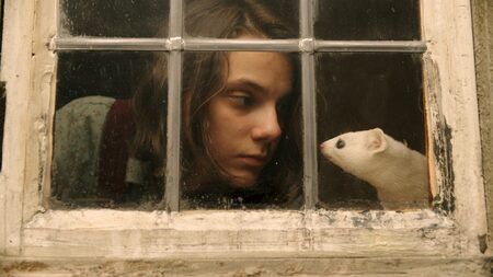 Lyra Belacqua (Dafne Keen) with her daemon Pantalaimon in His Dark Materials.