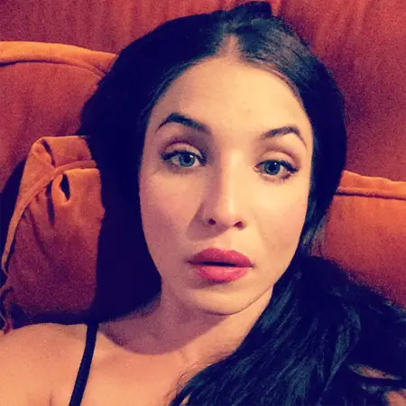 Alida Morberg lies on her couch while taking a selfie.