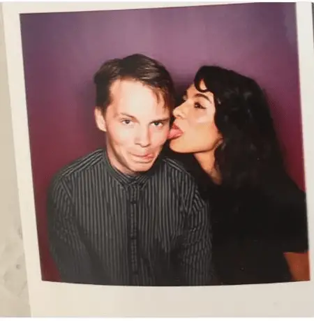 Aurora and Sam Strike, she is licking his cheek.