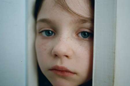 Alexa Swinton peering through the door.