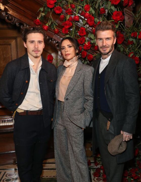Brooklyn Beckham with his parents.