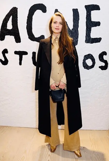 Hera Hilmar standing in front of Acne Studios logo and after she appeared in the show SEE