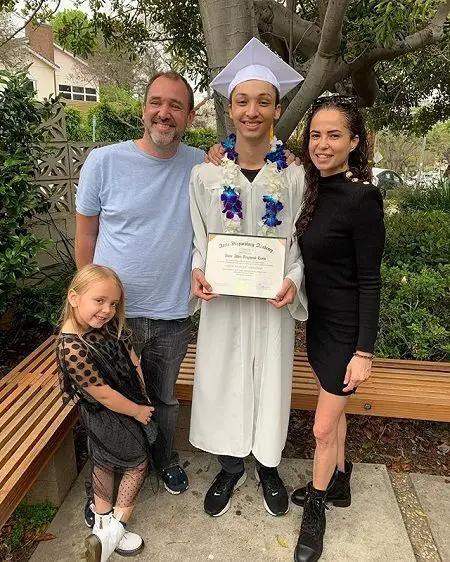 Trey (left), Kobe (center) in his white graduation gown, Boogie (right) and Betty (bottom left) attending Kobe's graduation ceremony. All smiling.
